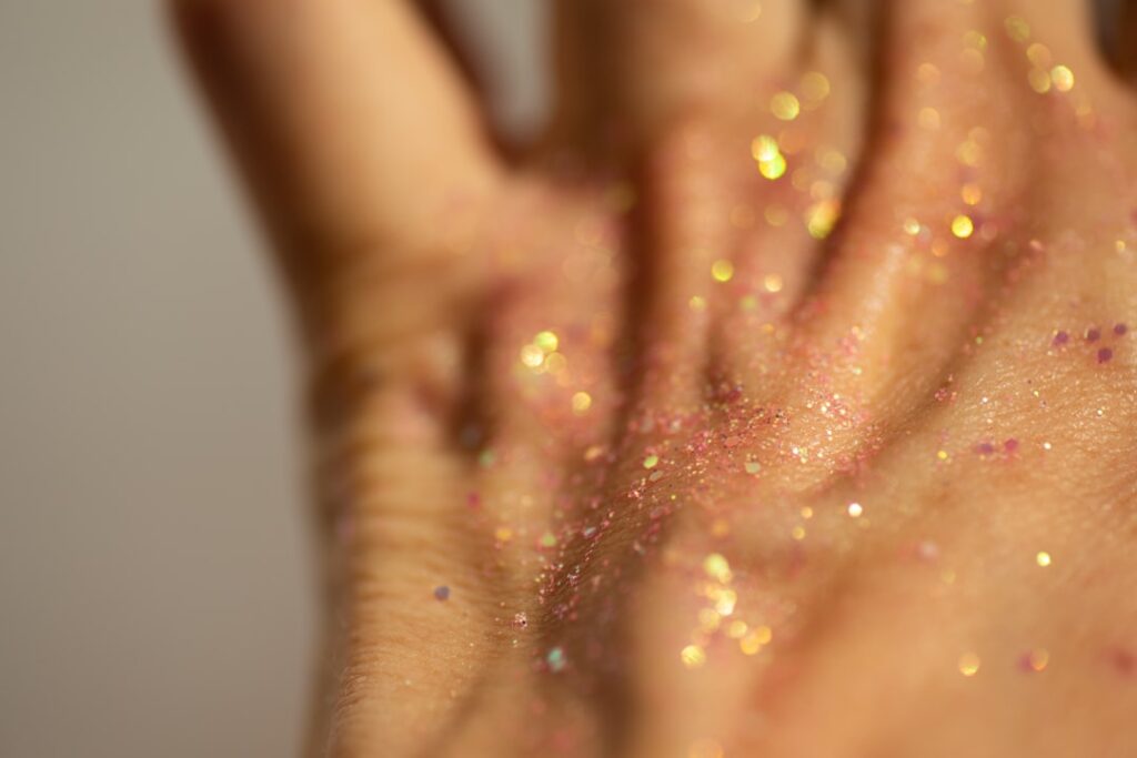 Close-up of a hand covered in glitter